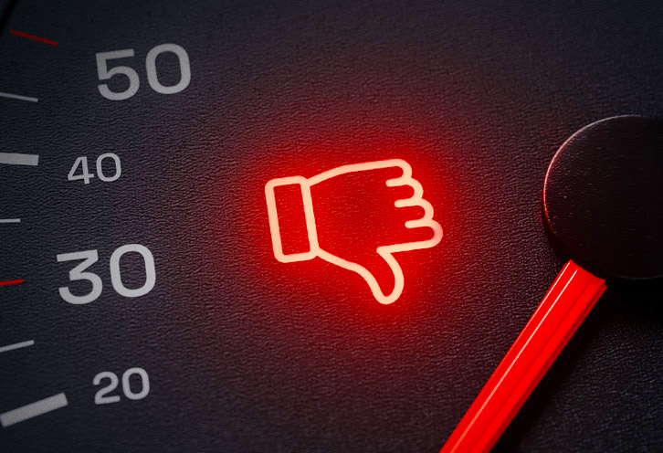 Image of a car dashboard with a thumbs down symbol