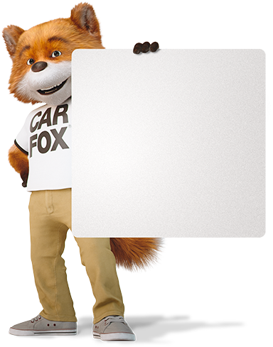 CARFAX Canada’s mascot, CAR FOX, holding a sign displaying some of CARFAX Canada’s most recent awards.